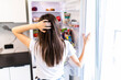 © F8  \ Suport Ukraine - Young woman in front of the fridge in the kitchen