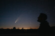 Young man on the background of the starry sky and comet NEOWISE. Comet C / 2020 F3 NEOWISE Observation