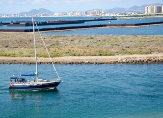 Poster - Beautiful view of boat sailing on the sea with buildings background