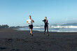 © puhhha - Beach. Sport Couple Running During Morning Workout. Handsome Man And Sexy Woman In Fashion Sporty Outfit Training On Coast. Active Summer Vacation At Tropical Ocean As Lifestyle.