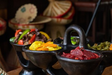 Wall Mural - Selective focus shot of delicious Ethiopian food with fresh vegetables on a wooden table