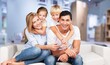 © BillionPhotos.com - Beautiful smiling family sitting at sofa at home