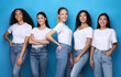 © Prostock-studio - Pretty Multicultural Girls Smiling Standing On Blue Studio Background