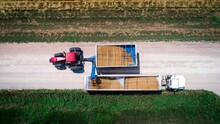Grain Cart Unloads Grain Into A Truck 