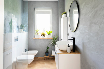 Wall Mural - Stylish grey bathroom with window, sink, mirror and modern furniture. Minimalism in scandinavian interior. 