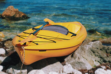 Close Up Yellow Kayak Boat On The Seaside. Summer Water Activity Kayaking. Crimea, Black Sea.