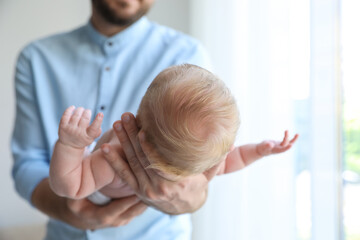 Poster - Father holding his newborn baby at home, closeup