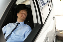 Tired Young Man Sleeping In His Modern Car