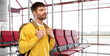 © Syda Productions - travel, tourism and people concept - sad unhappy young man with backpack over airport terminal background