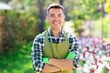 © Syda Productions - gardening and people concept - happy smiling middle-aged man in apron with crossed hands at summer garden