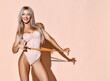 Fitness perfect body weight loss concept. Blonde slim woman hold tape measure measuring waist smiling pointing at result