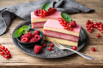 Delicious and refreshing juicy dessert, punch cake topped with sugar icing and fresh raspberries and red currants