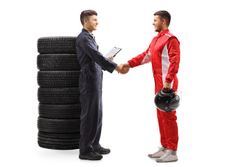 Wall Mural - Auto mechanic shaking hands with a professional racer