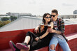 © mirage_studio - Happy smiling couple toasting and drinking beer at outdoor pub or bar on rooftop at summer, copy space
