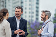 © PhotoAlto - Businesspeople talking in public park