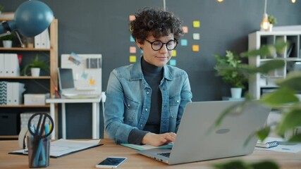 slow motion of young successful businesswoman working with laptop computer in creative office focuse