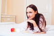 © iordani - young pretty brunette woman laying in bed, luxury white interior vintage having breakfast cute