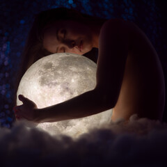 Wall Mural - female magic, astronomy and the zodiac. a beautiful girl holds the moon against the background of st