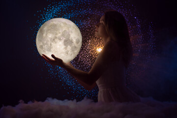 Wall Mural - night magic and astronomy, the universe and space, female magic, a girl with the moon in her hands s