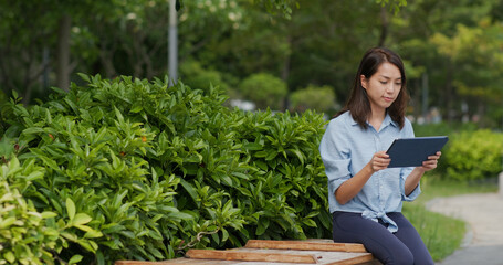 Sticker - Woman look at tablet computer at outdoor