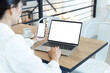© panitan - computer,cell phone mockup image.hand woman work using laptop texting mobile.blank screen with white background for advertising,contact business search information on desk in cafe.marketing,design