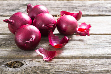 Wall Mural - spanish onions on old rustic wood table background