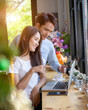 © PK Studio - Asian young  girl and guy working with laptop in coffee shop cafe
