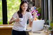 © PK Studio - Asian woman or a happy student smiles on a desk with a computer.