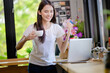 © PK Studio - Asian woman or a happy student smiles on a desk with a computer.