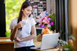 © PK Studio - Asian woman or a happy student smiles on a desk with a computer.