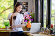 © PK Studio - Asian woman or a happy student smiles on a desk with a computer.