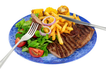 Wall Mural - Grilled sirloin steak and French fries meal with fresh salad and sweetcorn cobs isolated on a white background