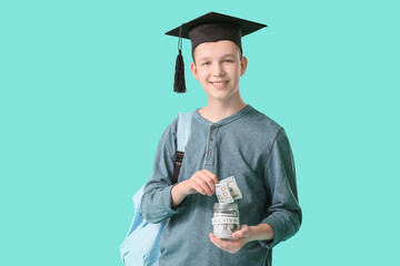 Teenage boy with savings for education on color background