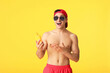 © Pixel-Shot - Happy young man with sun protection cream on color background