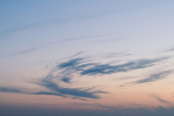 Wall Mural - cloudy sunset with clouds in the wind