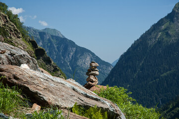 hiking in the mountains, a mound of stones in mountains