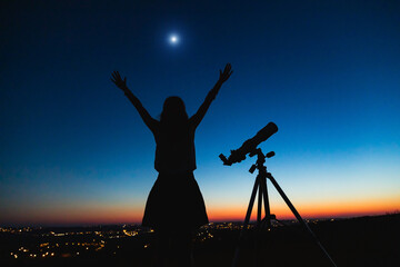 Wall Mural - silhouette of a woman and telescope with twilight sky.