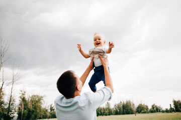 A happy family walks with a child in nature