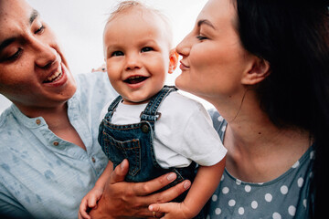 Wall Mural - A happy family walks with a child in nature