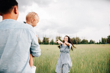 Poster - A happy family walks with a child in nature