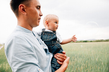 Poster - A happy family walks with a child in nature