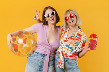 Portrait of two cheerful lovely girlfriends standing