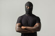 © Alexandr - young african man in a black mask and a black t-shirt on a gray background