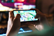 Image closeup of focused man playing video game on mobile phone