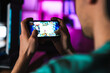 © Drobot Dean - Image closeup of focused man playing video game on mobile phone