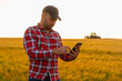 © Aleksandar - Farmer close-up holding and working on tablet in a wheat field. Copy space of the setting sun rays on horizon in rural meadow Close up nature photo Idea of a rich harvest