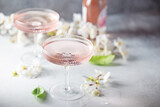 Fototapeta  - Homemade pink vodka cosmopolitan cocktail drink in crystal glasses
