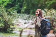 © Farknot Architect - A female traveler with backpack walking  by mountain stream for hiking concept