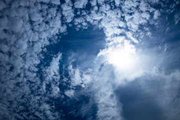 sunshine and white fluffy clouds in the blue sky .blue sky background with tiny clouds