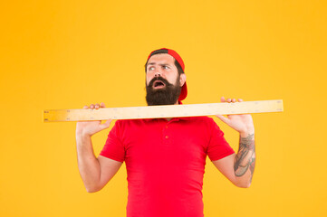 Wall Mural - Size of parcel. Post office worker with ruler. Big size. Measuring tool. Man holding ruler on yellow background. Bearded man preparing for maths. Hipster man in cap with big measuring instrument